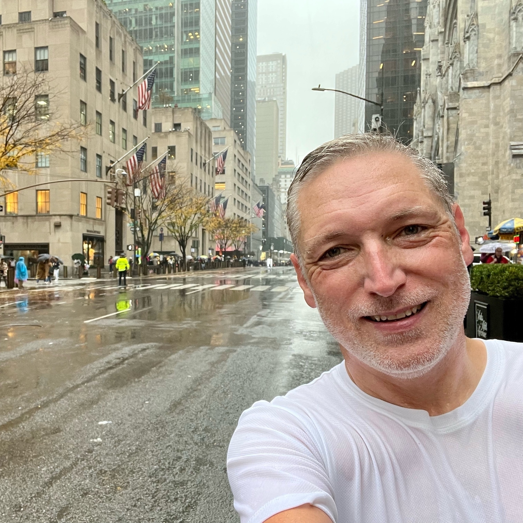 selfie against backdrop of rainy fifth Avenue. Soaked to the bone in running gear.
