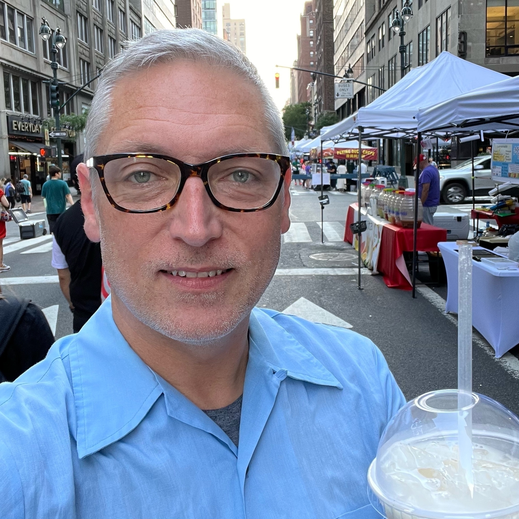 selfie on nyc street holding a plastic cup with horchata drink