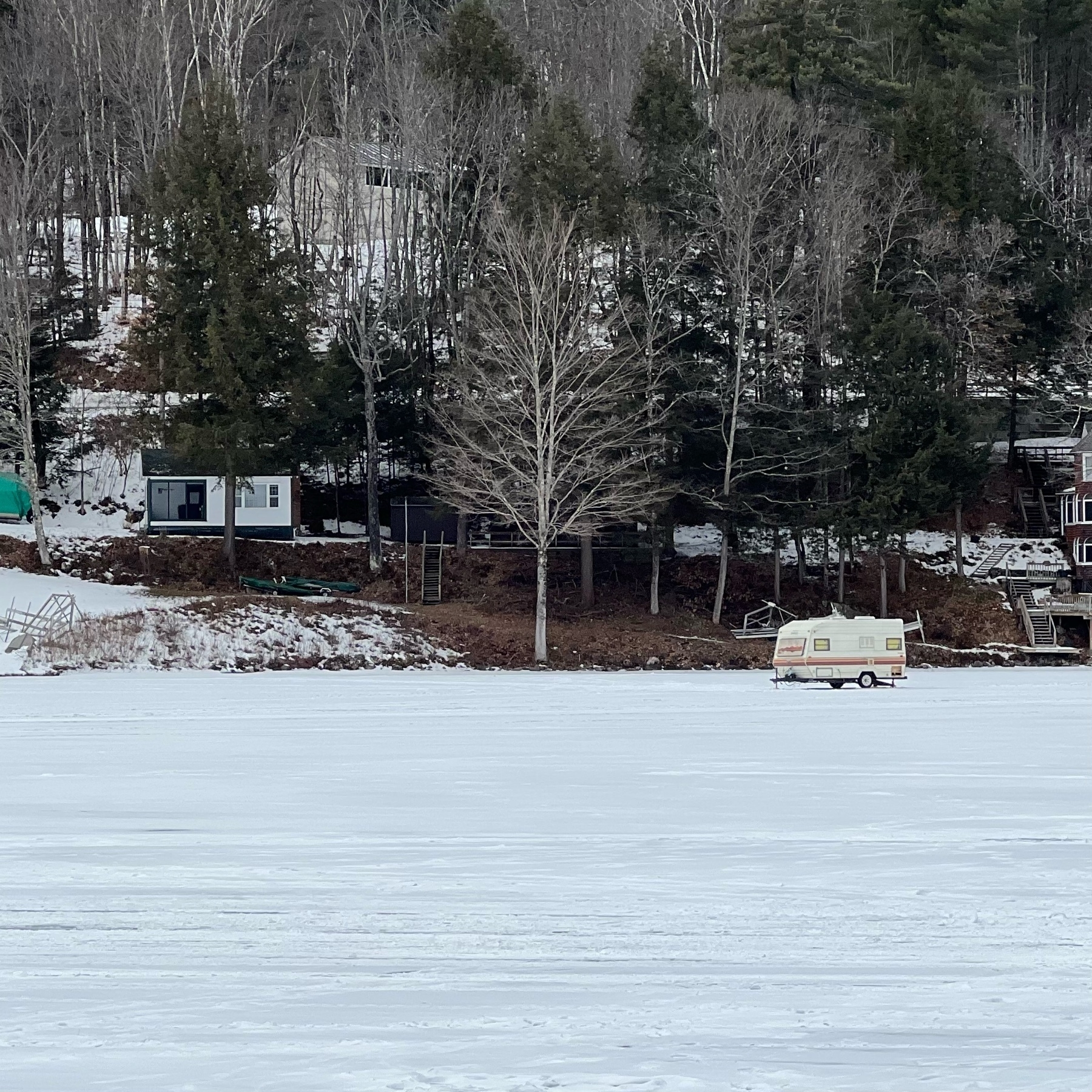frozen lake with camper shell parked on it