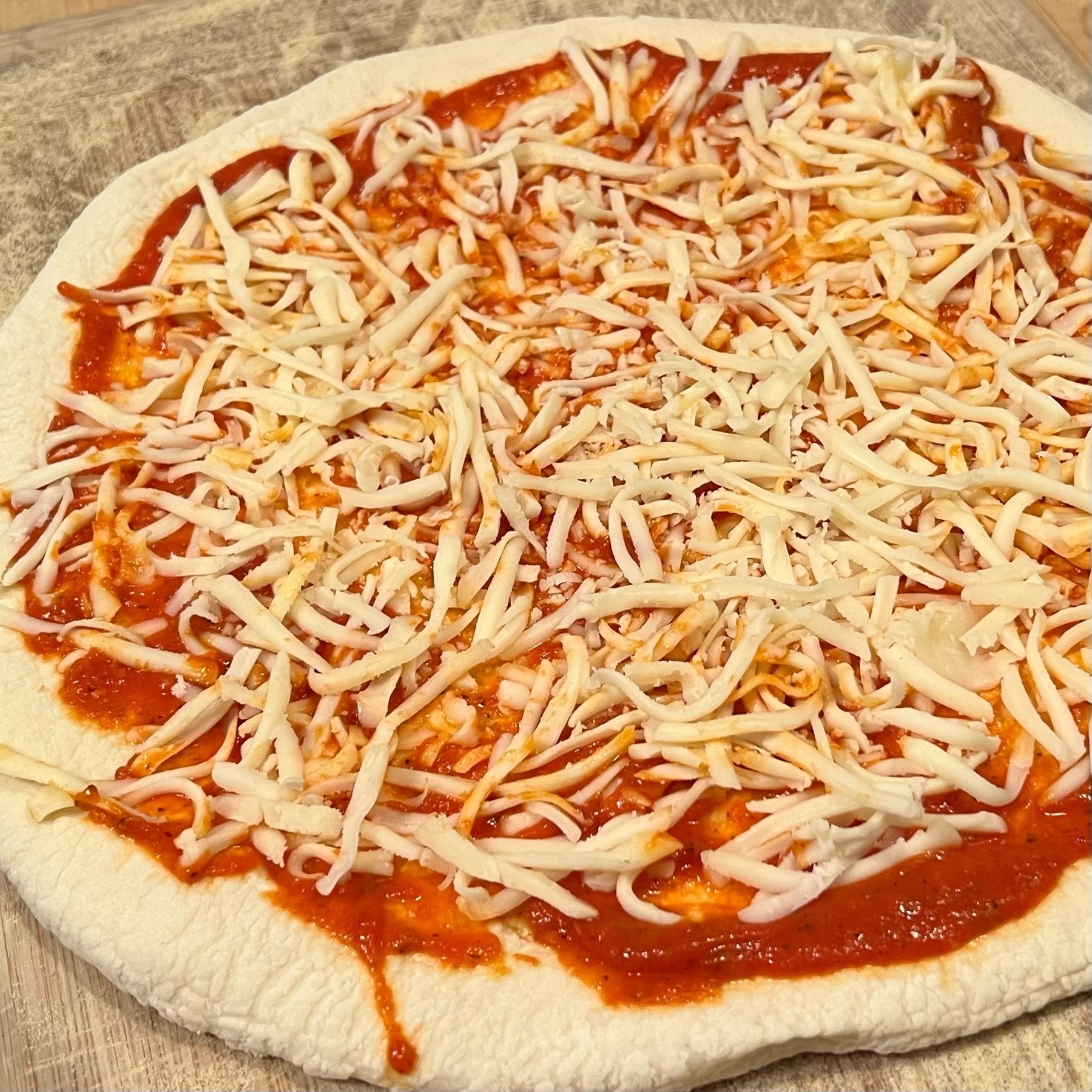 uncooked pizza with cheese