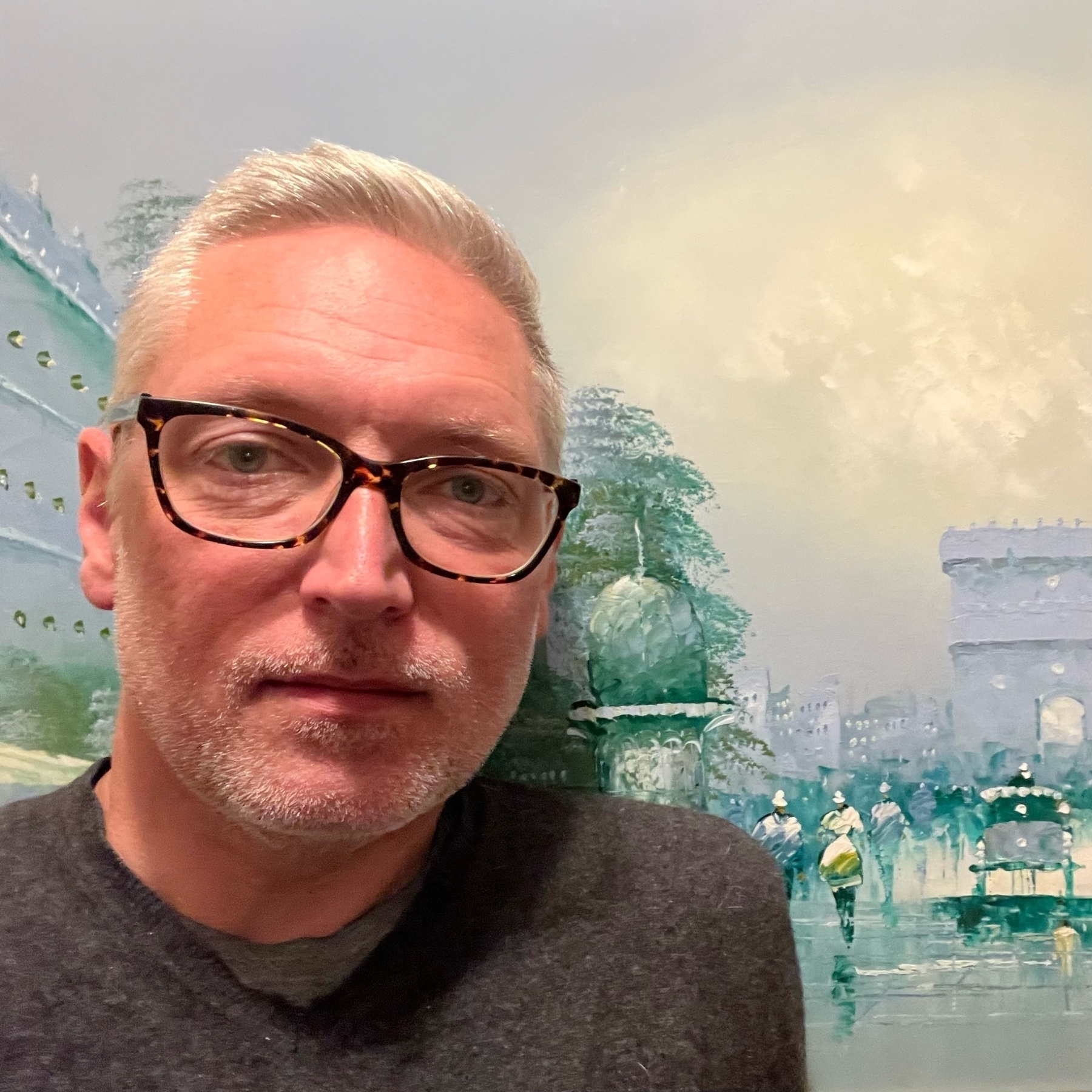 selfie against a painting of Paris - maybe Champs Elysses? -  impressionist dtule with lots of blues and greens