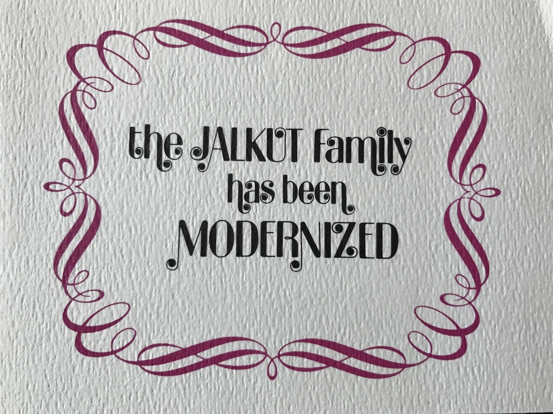 Holiday card on paper with decorative art around the words "The Jalkut Family has been MODERNIZED"