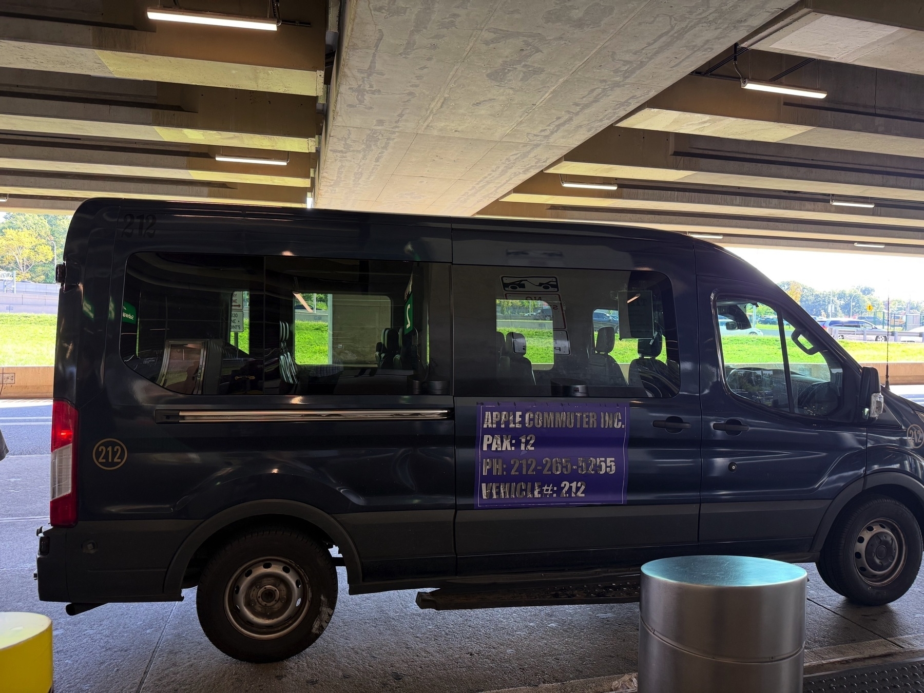 Airport shuttle bus with a label on the side reading “Apple Commuter, Inc.”