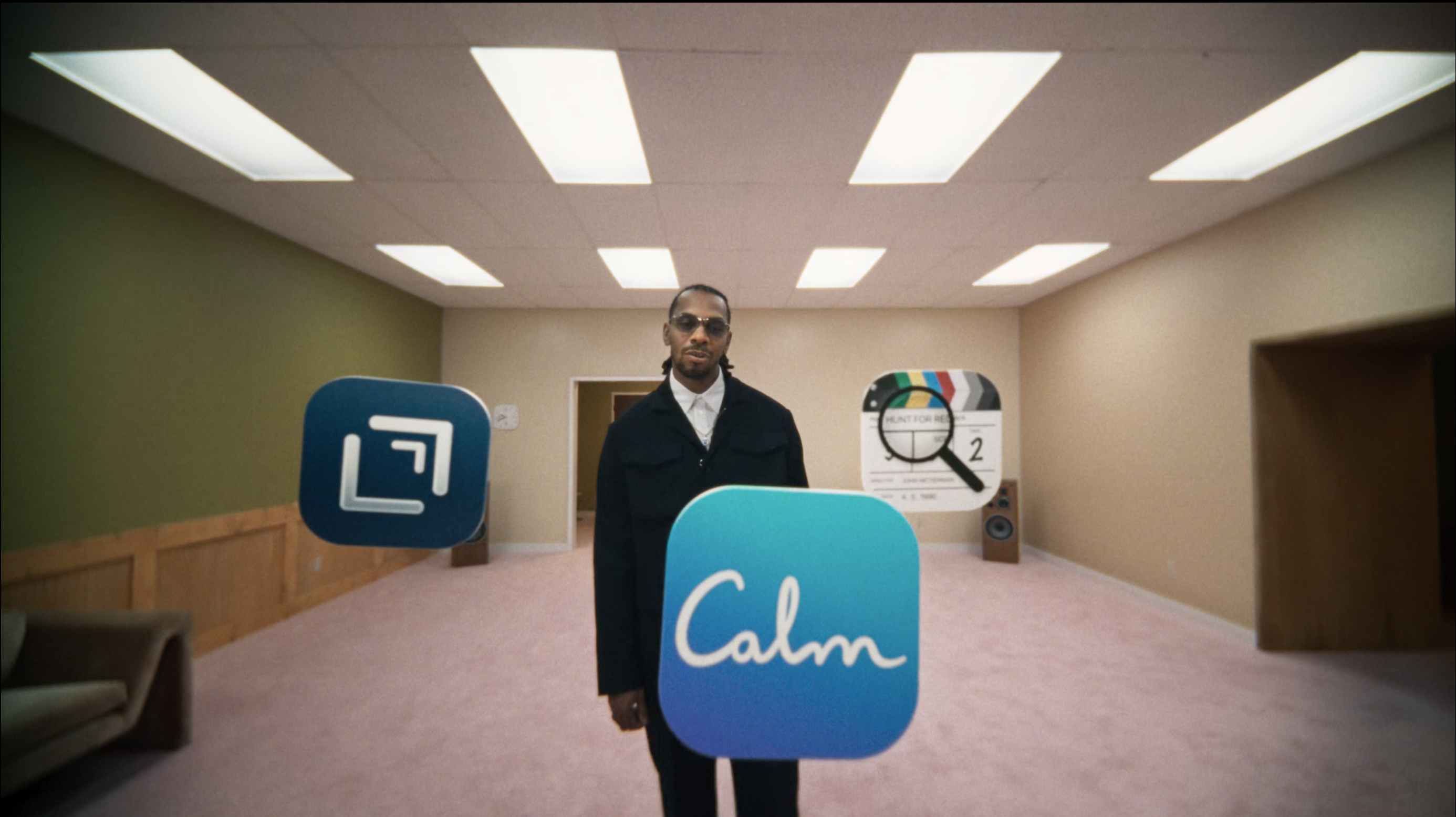 Still frame from Apple’s WWDC 26 keynote closing video, showing a rapper with floating app icons around him, including Casey Liss’s own “Callsheet” app.