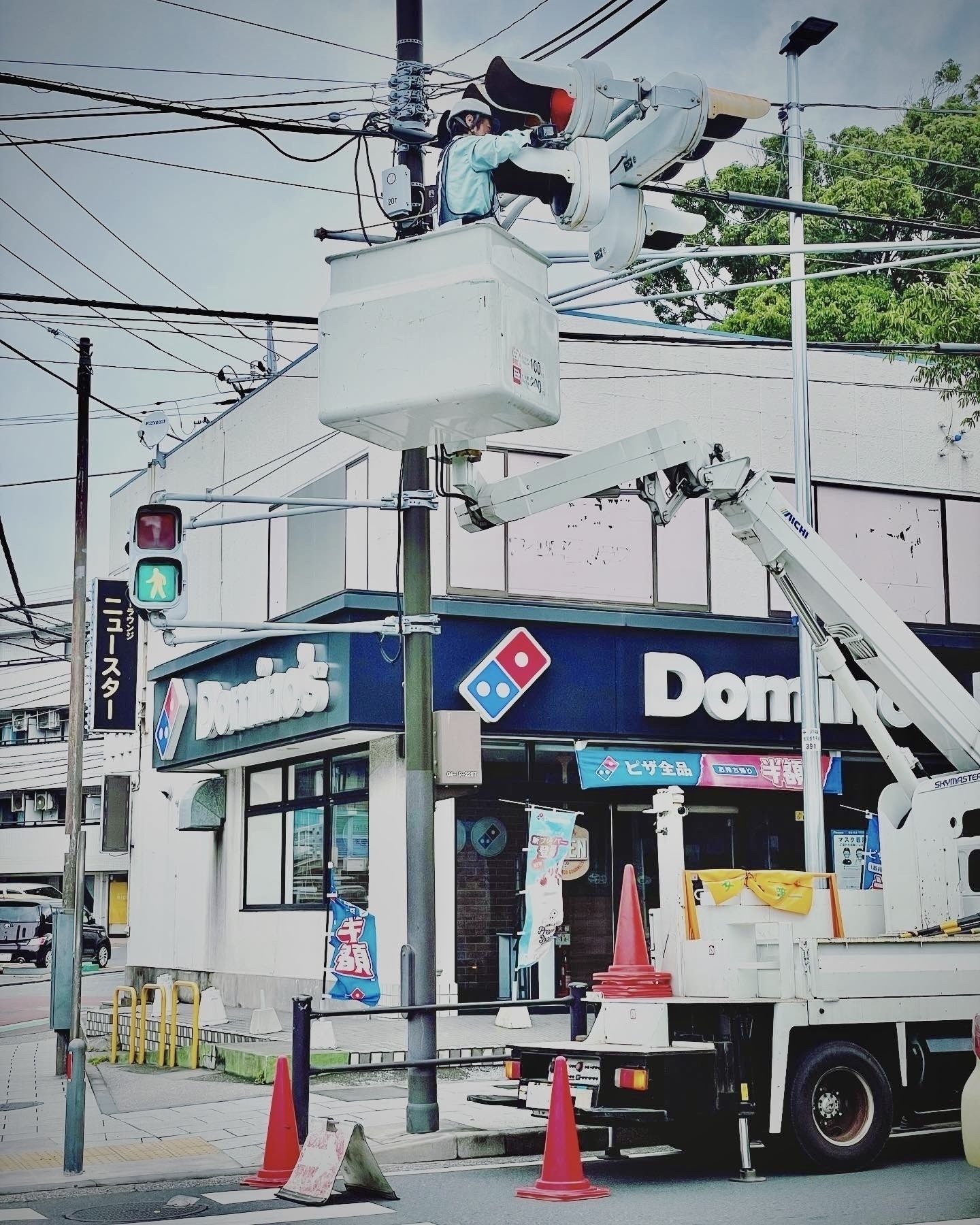 Photo of a worker in a cherry picker working on a traffic signal. 