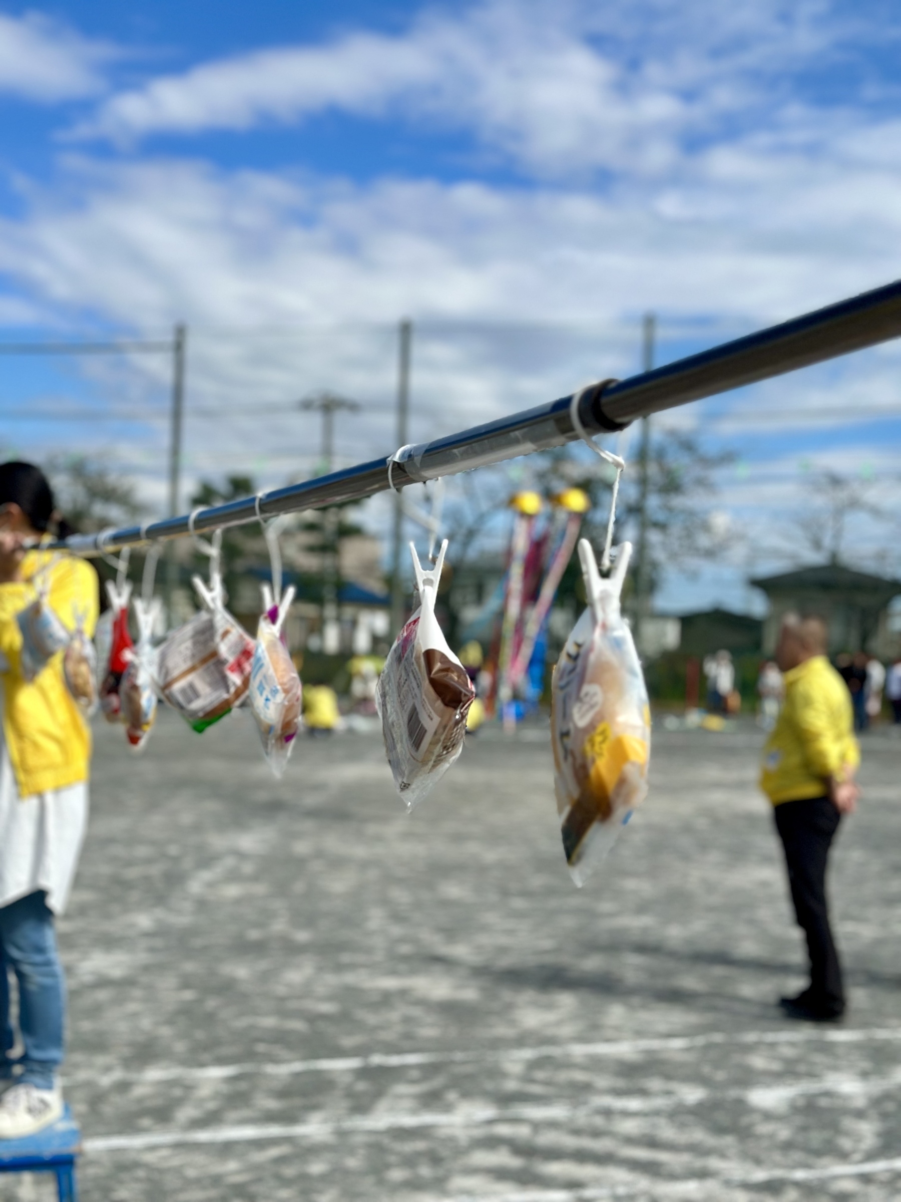 Bread packages hanging from a laundry pole. 
