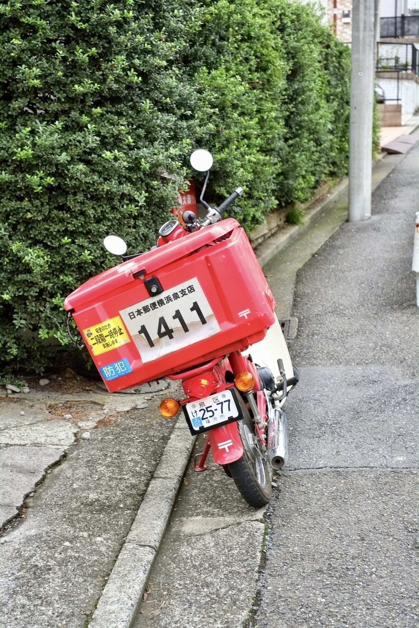 Red Honda SuperCub mail delivery bike. 
