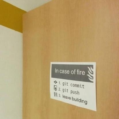 Jokey sign telling ppl to git push before leaving in case of fire