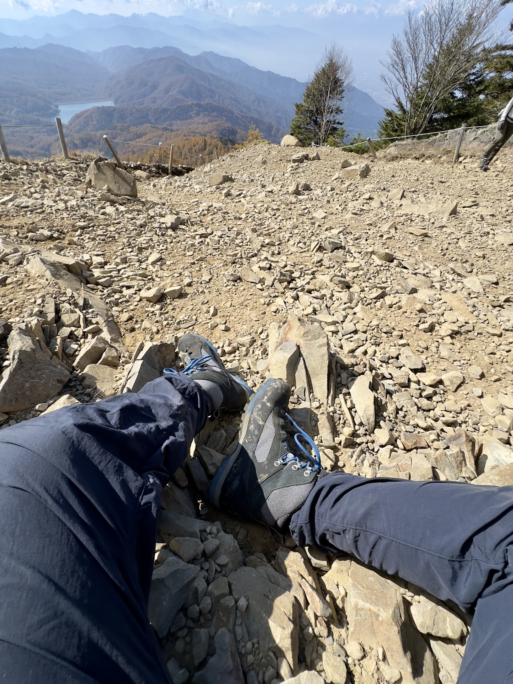 Man’s legs and rocky surface of area near summit of Mt. Daibosatsu.