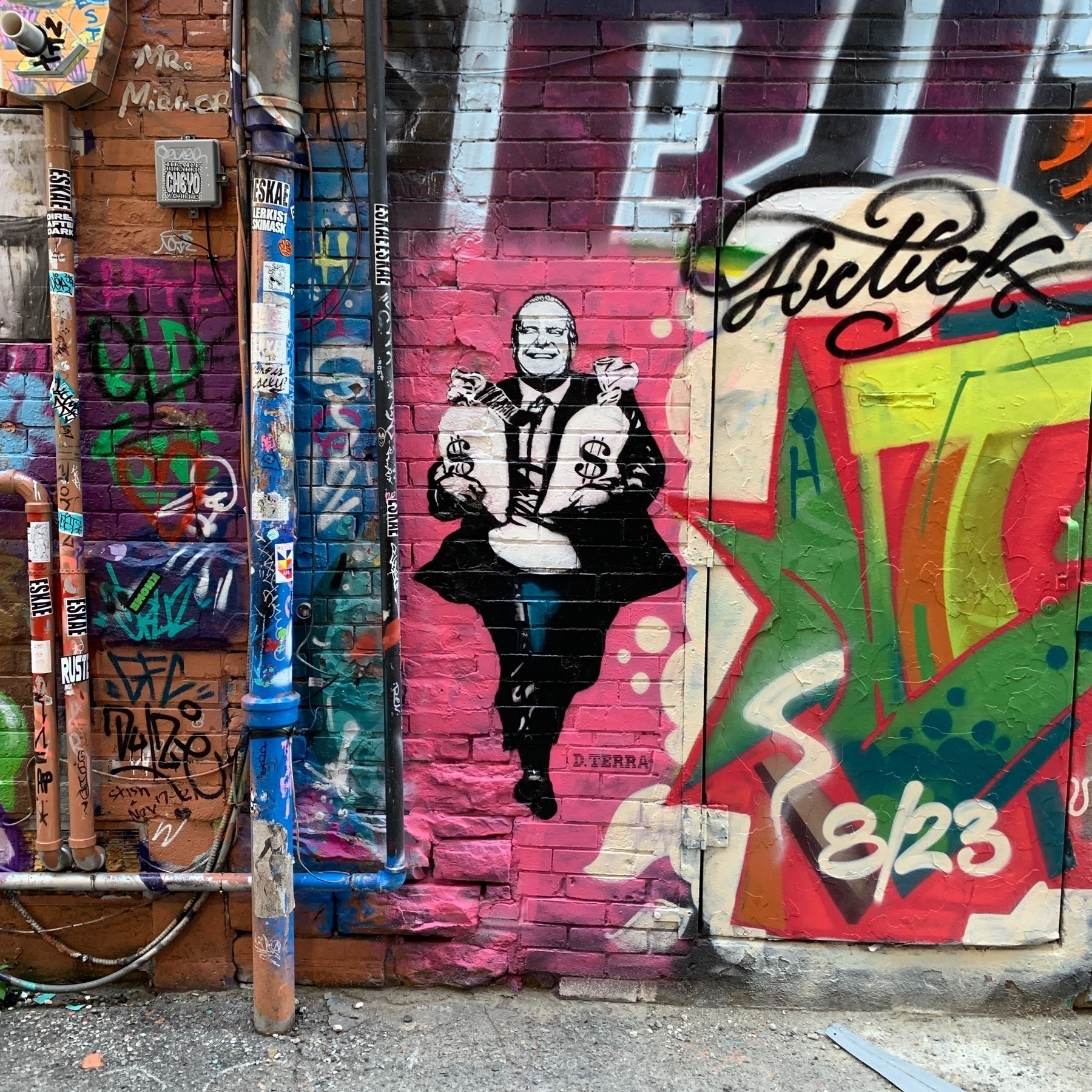 Street art of Doug Ford (current premiere Ontario) holding two large sacks of money.