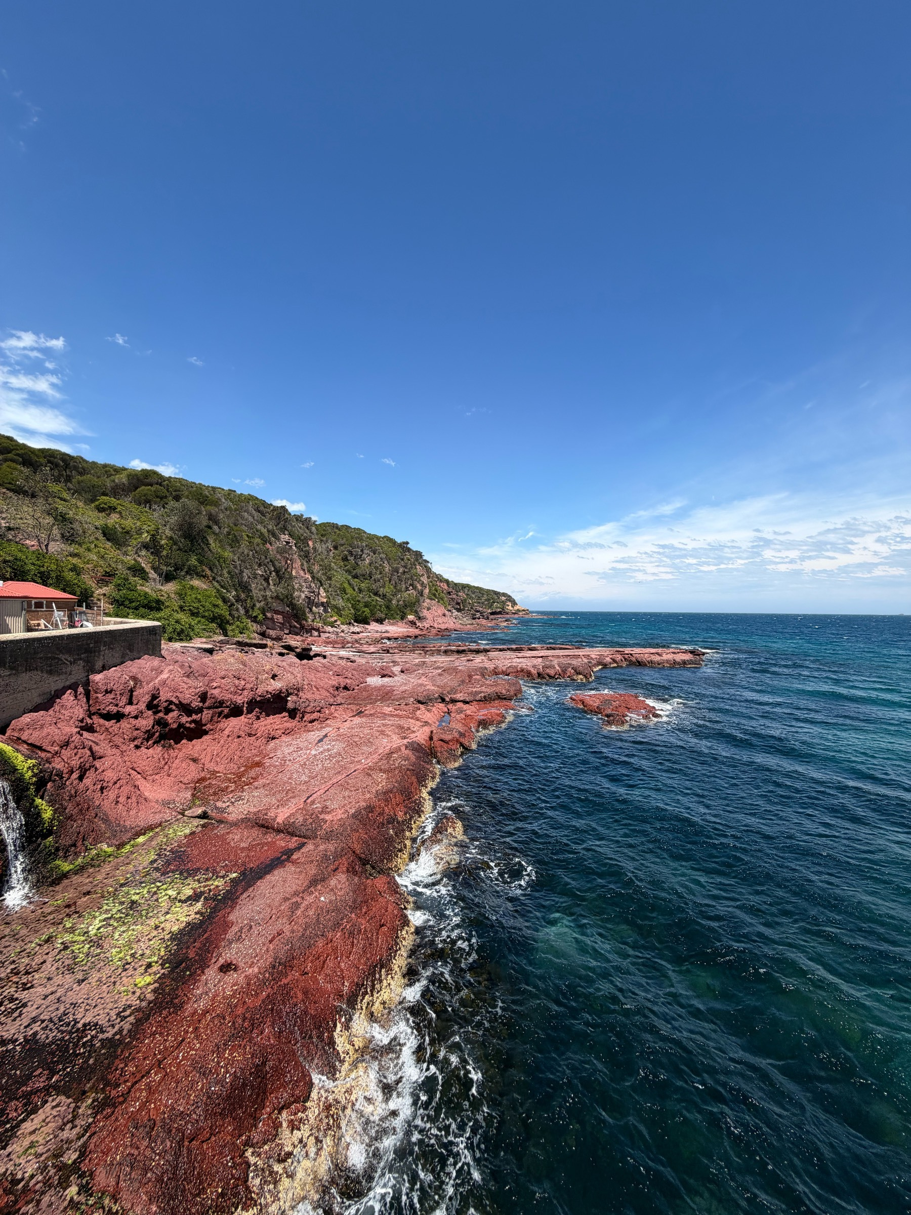 Red rocks next to the ocean