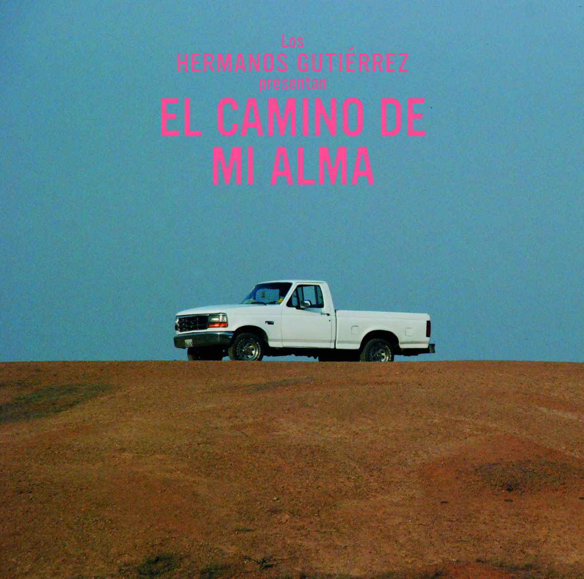 The cover of El Camino De Mi Alma by Hermanos Gutierrez, showing a white pickup truck against a blue sky, with pink text above.