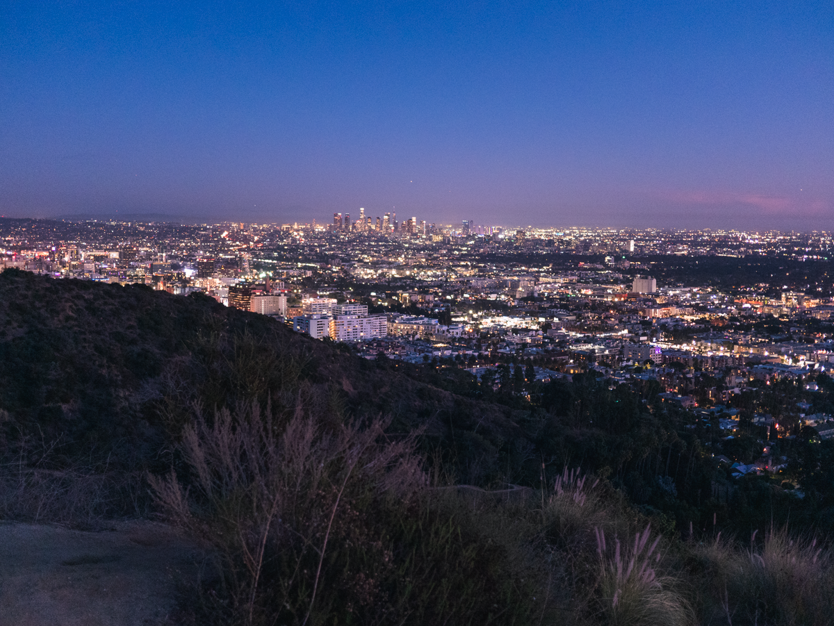 A photograph of downtown Los Angeles at dusk, from up in the Hollywood Hills