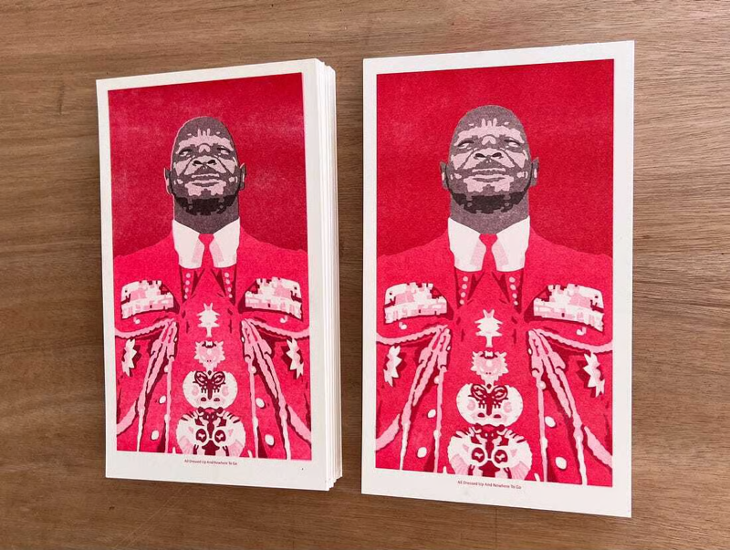 5da40db6-5e4c-41ce-8efc-588a46830de1_3282x2473.jpg.png A photo of two stacks of risoprinted illustrations showing a man in a red jacket festooned with medals