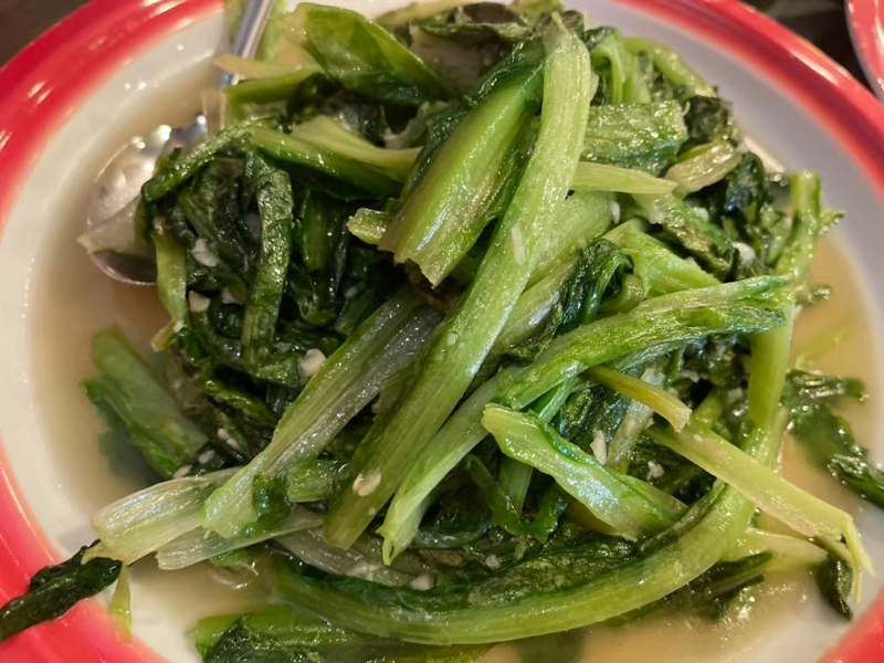 A photo of steamed greens on a plate