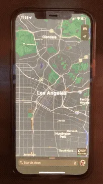 a gif video showing a finger navigating Apple Maps on an iPhone, opening a street view panorama, pointing up at the sky, and causing the display to spin around wildly