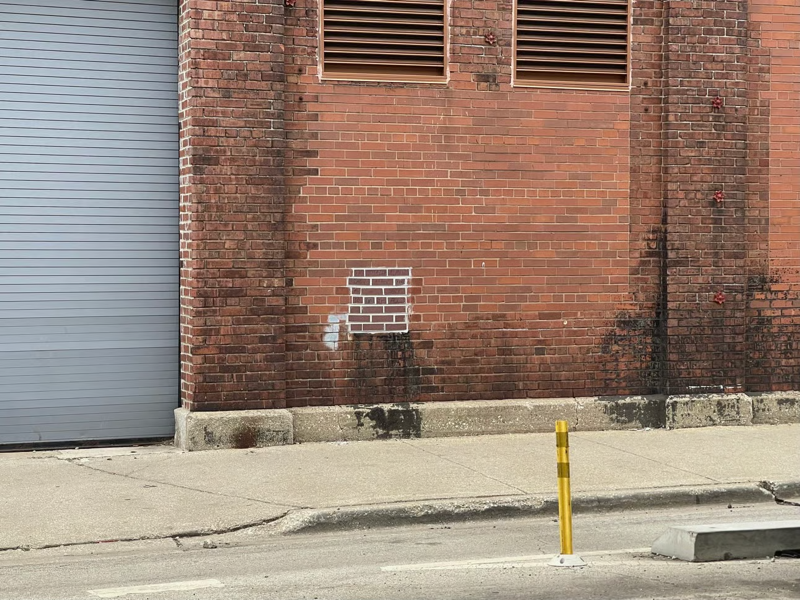 A photo of a stained-looking brick wall