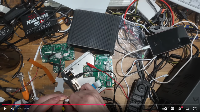 Screenshot_2025-09-15_at_12.54.37_AM.png.png A still from a Youtube video showing electronic cables and chips scattered on a table
