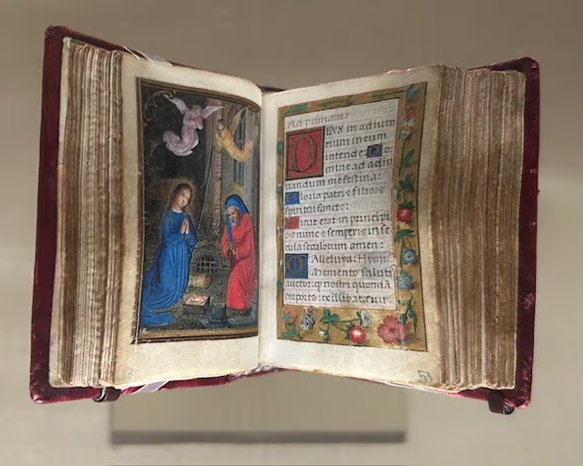 A photo of a tiny illuminated manuscript