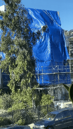 A short video of a giant blue tarp waving and billowing in the wind.