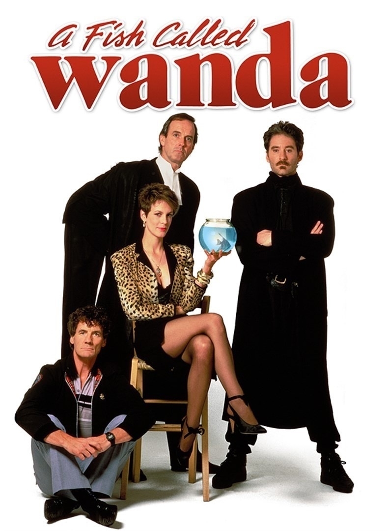 Four adults pose against a white background, one holding a fishbowl; promotional material for 'A Fish Called Wanda.'