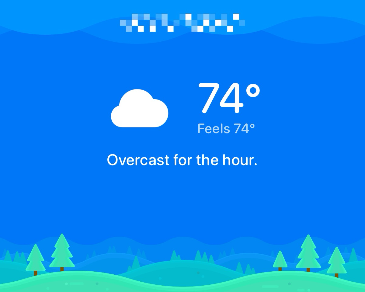 A white cloud icon indicating overcast weather, with text showing '74° Feels 74° Overcast for the hour,' against a blue background featuring illustrated green trees and hills.