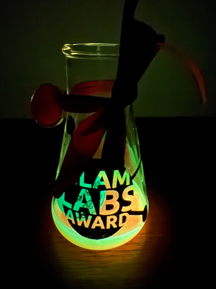 Photograph of the award glowing in the dark.