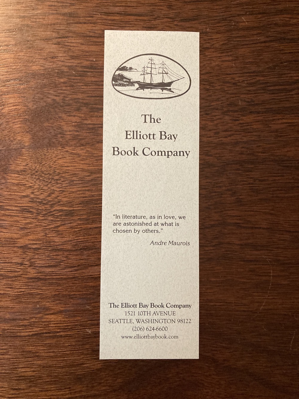 A bookmark with a drawing of an old three-mast schooner at the top. Below, a quote from Andre Maurois: In literature, as in love, we are astonished at what is chosen by others.