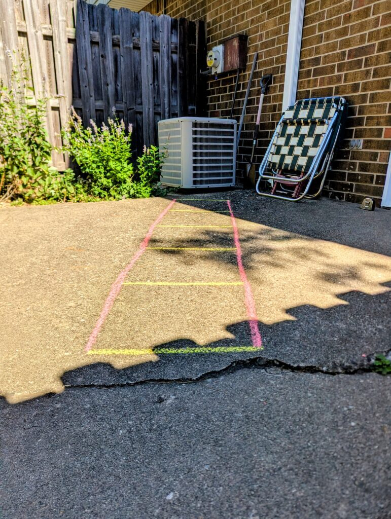 An agility ladder drawn on a patio with sidewalk chawk