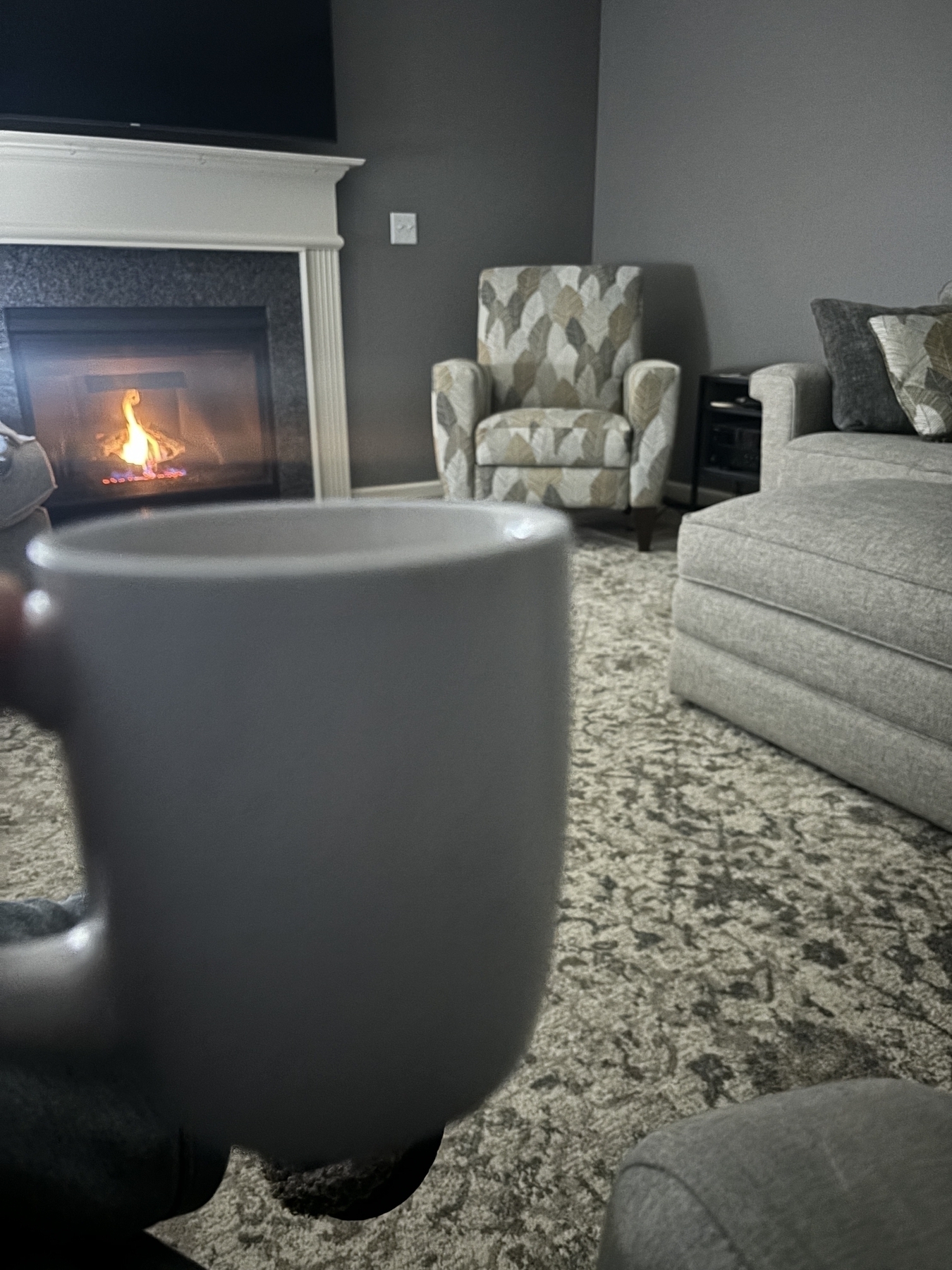 White coffee mug in front of an inviting fire