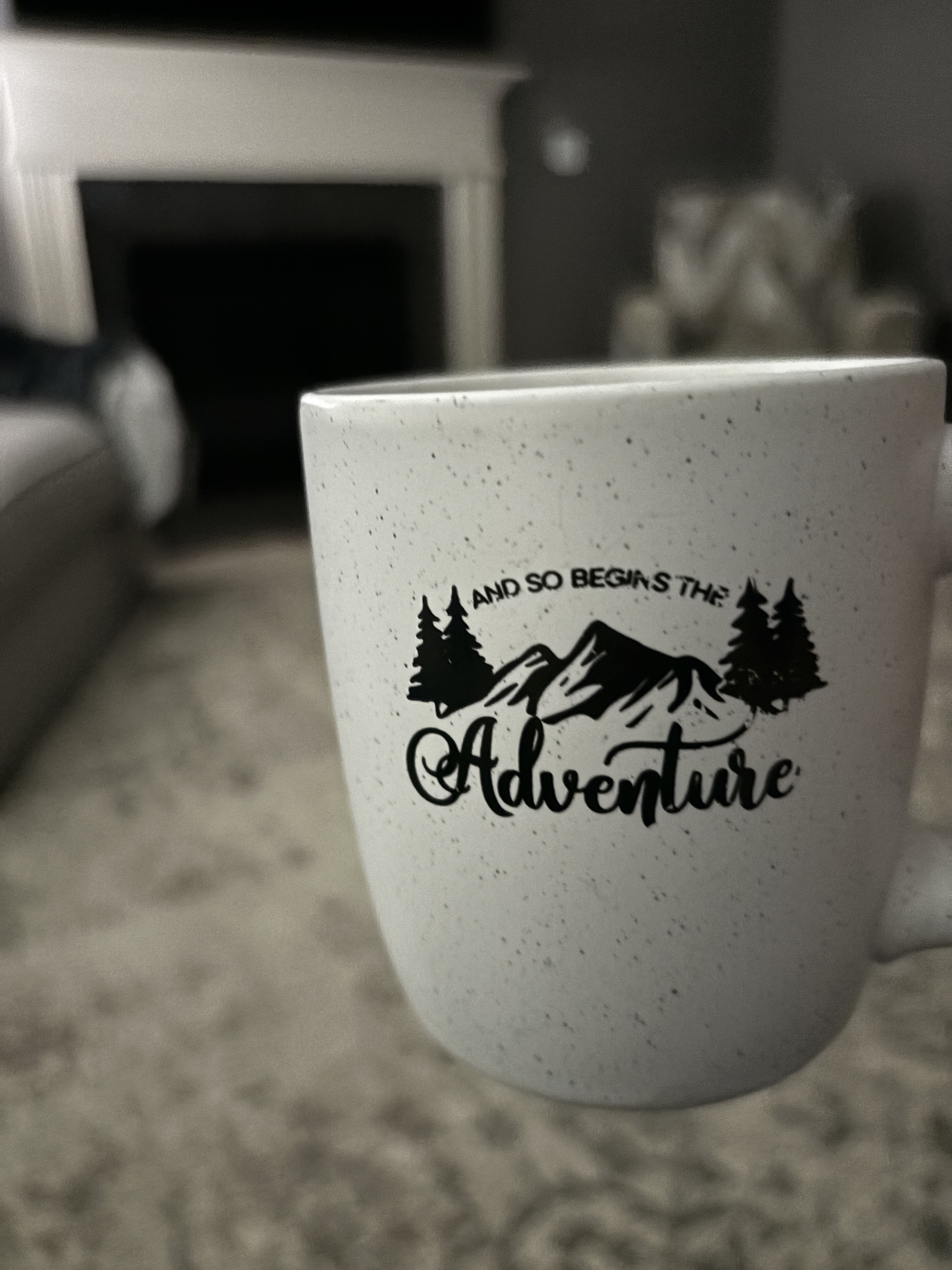 a coffee mug that says “so begins the adventure”