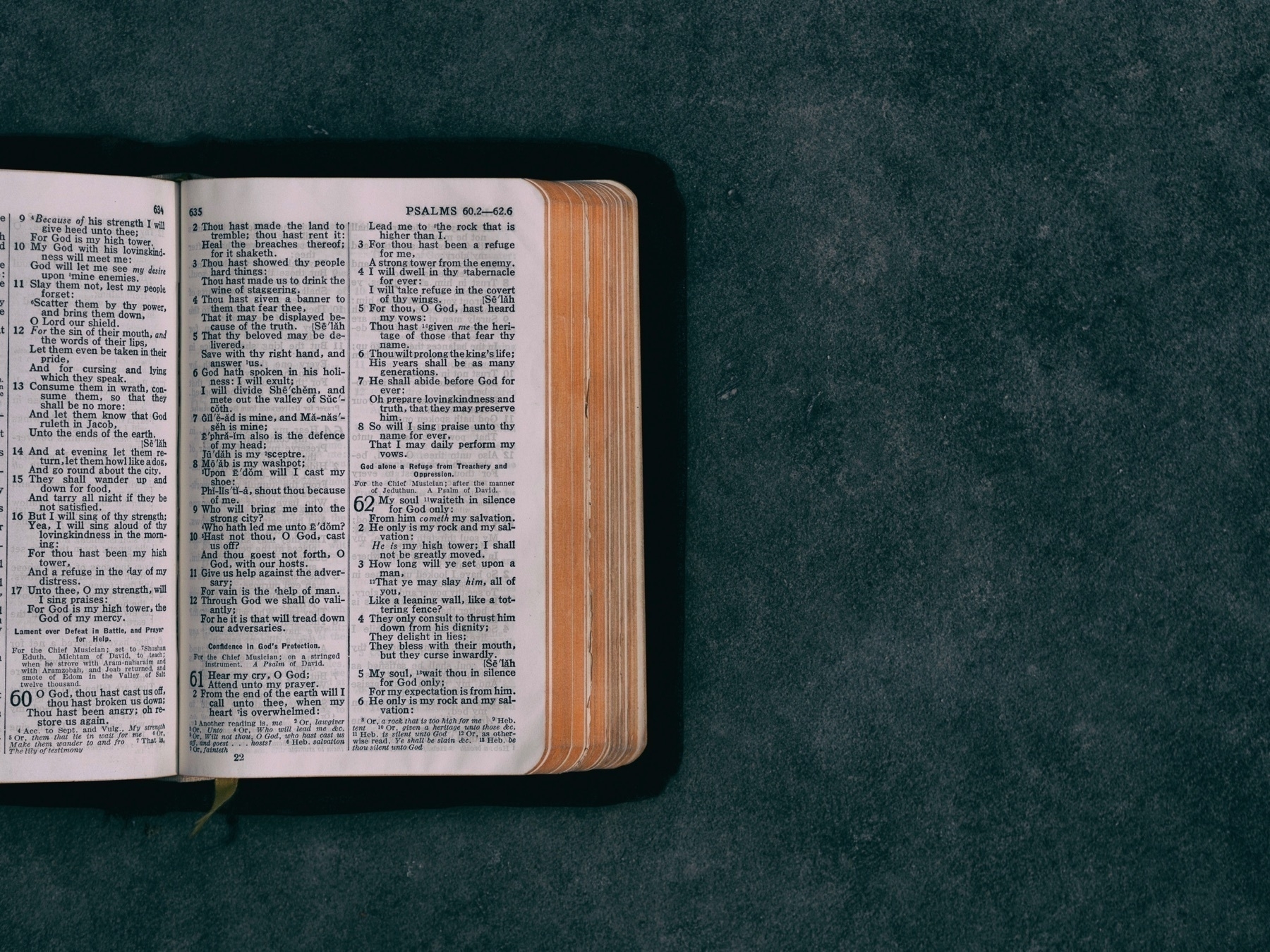 A bible open on an a gray countertop