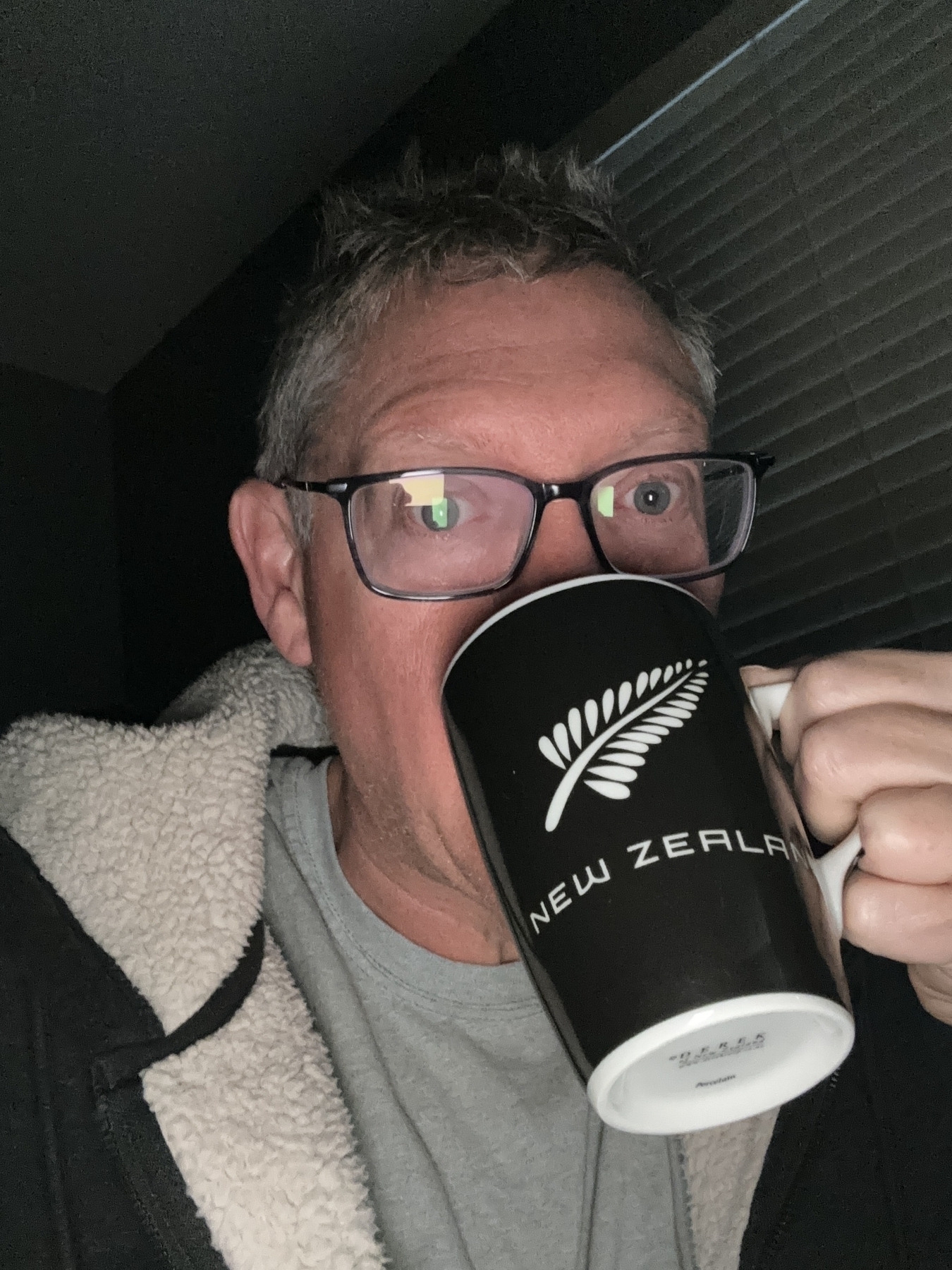 A dude with an All Blacks coffee cup