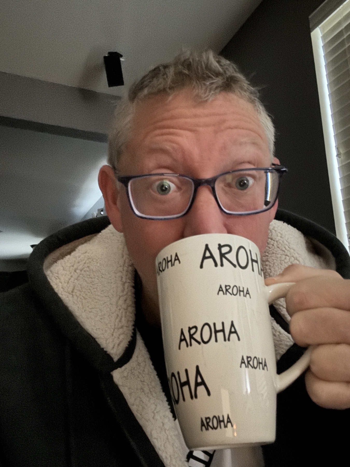 A Middle Aged man sipping from a coffee mug 