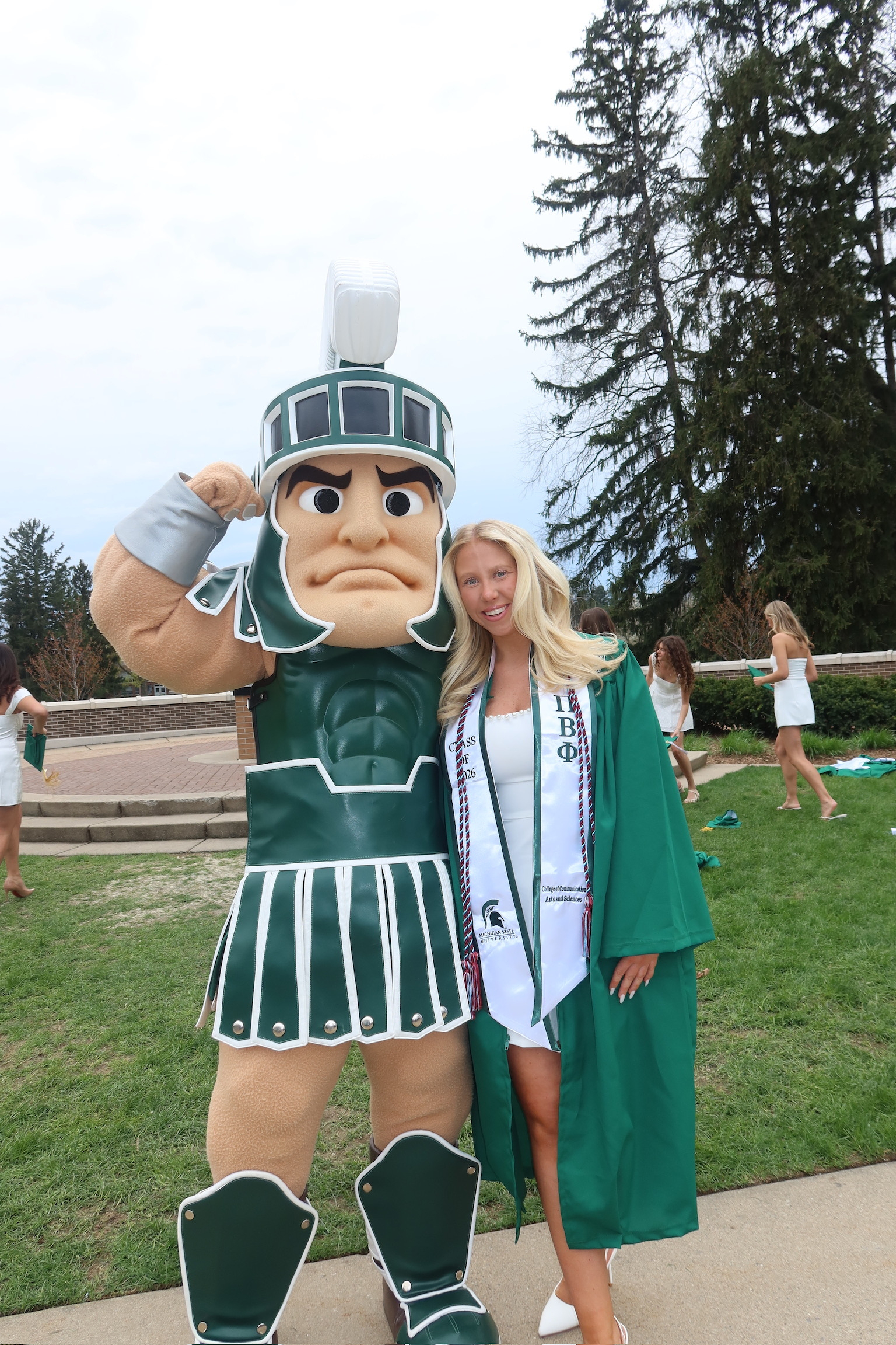 My daughter, Libby in her graduation gown posing with Sparty