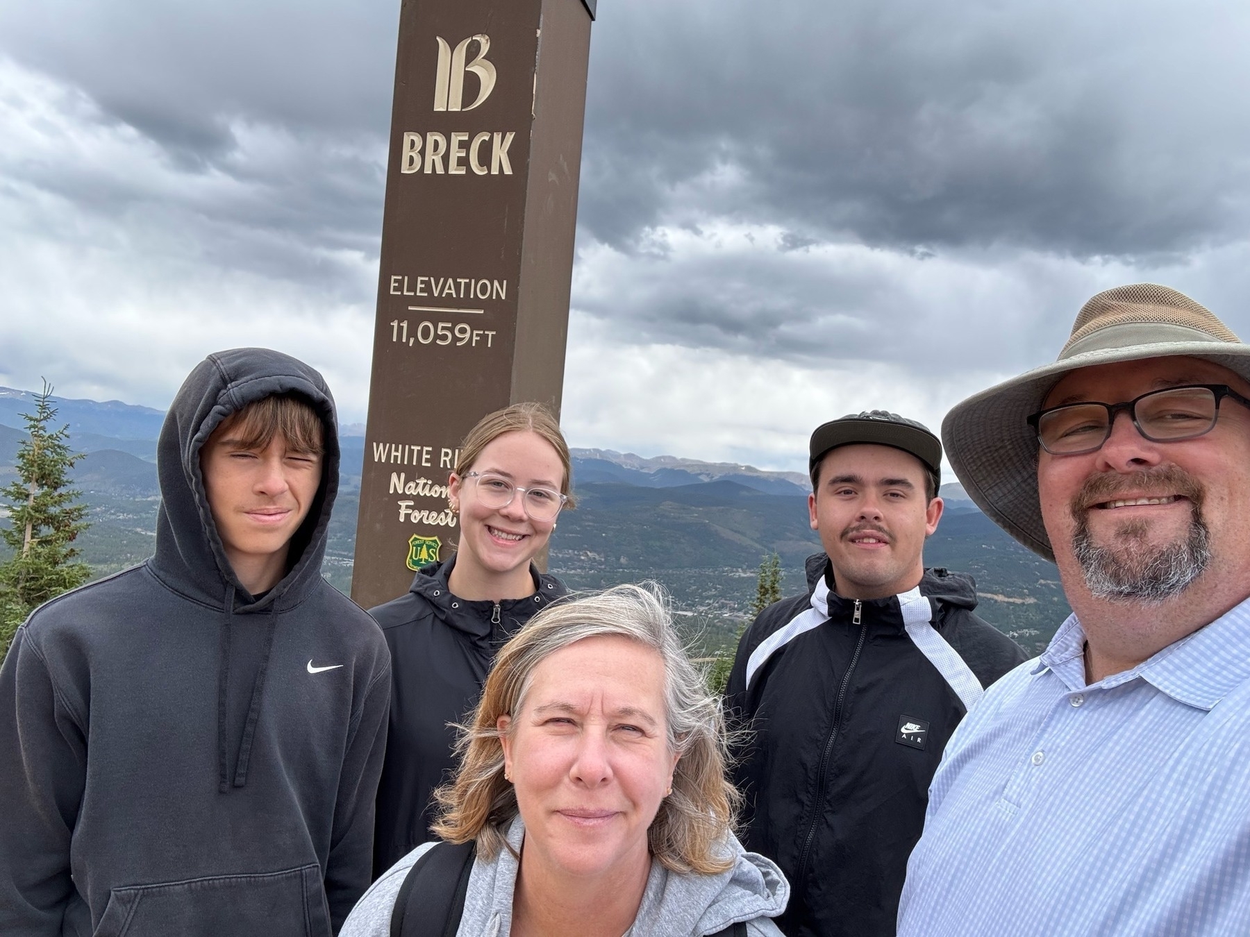 The family taking a selfie at the elevation post of Peak 8, Breckinridge