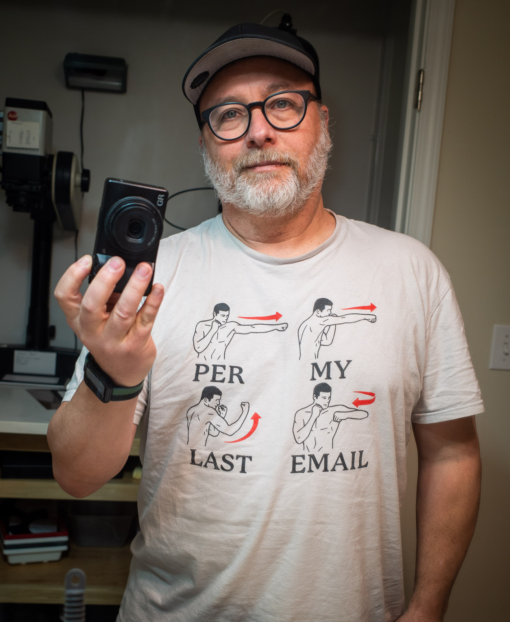 Self-portrait wearing T-shirt saying Per My Last Email