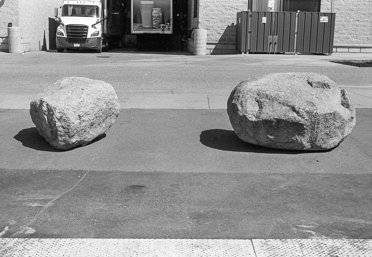 Black and white film photo of two large rocks