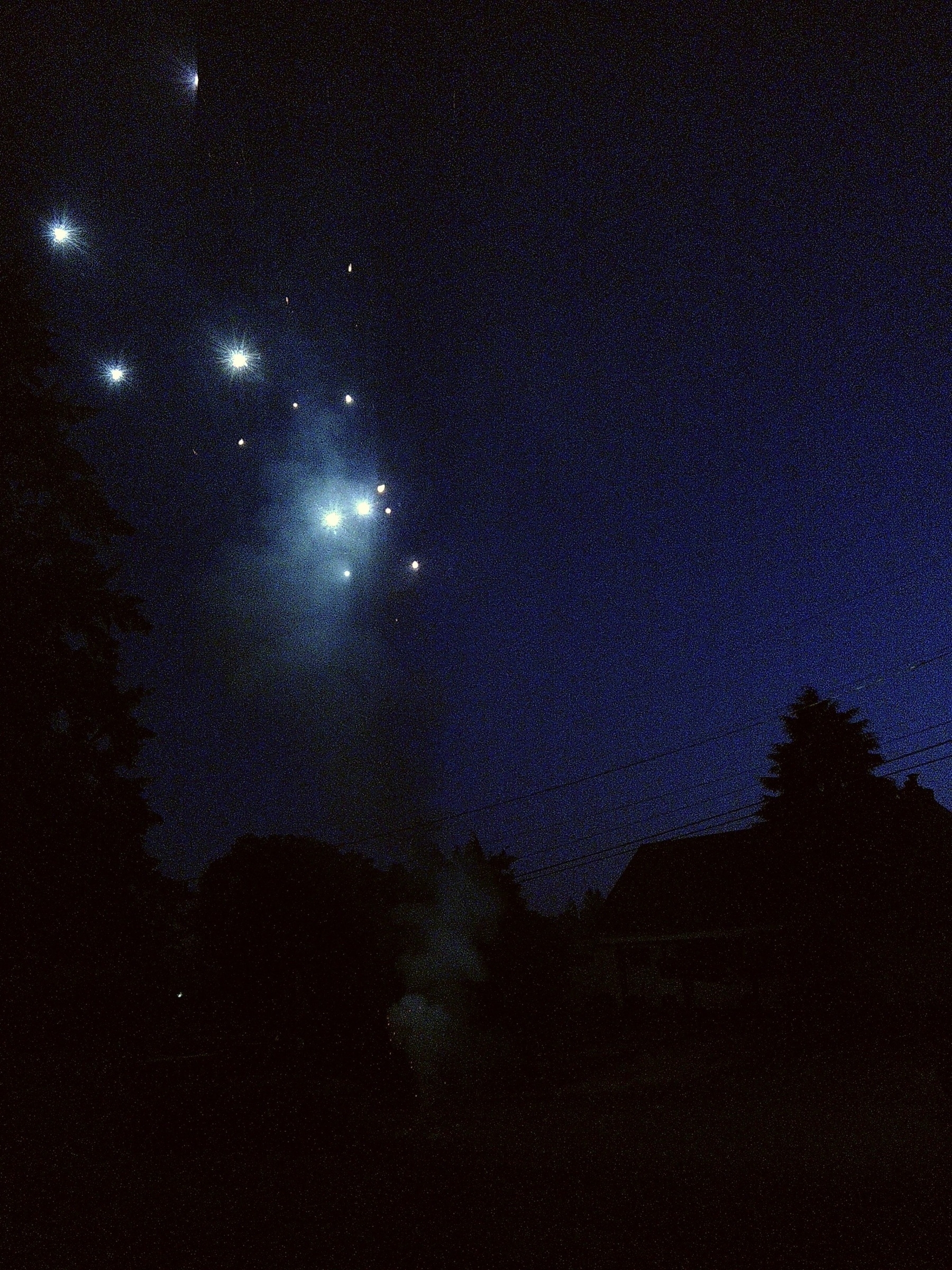 blue fountain style fireworks shooting upwards at night