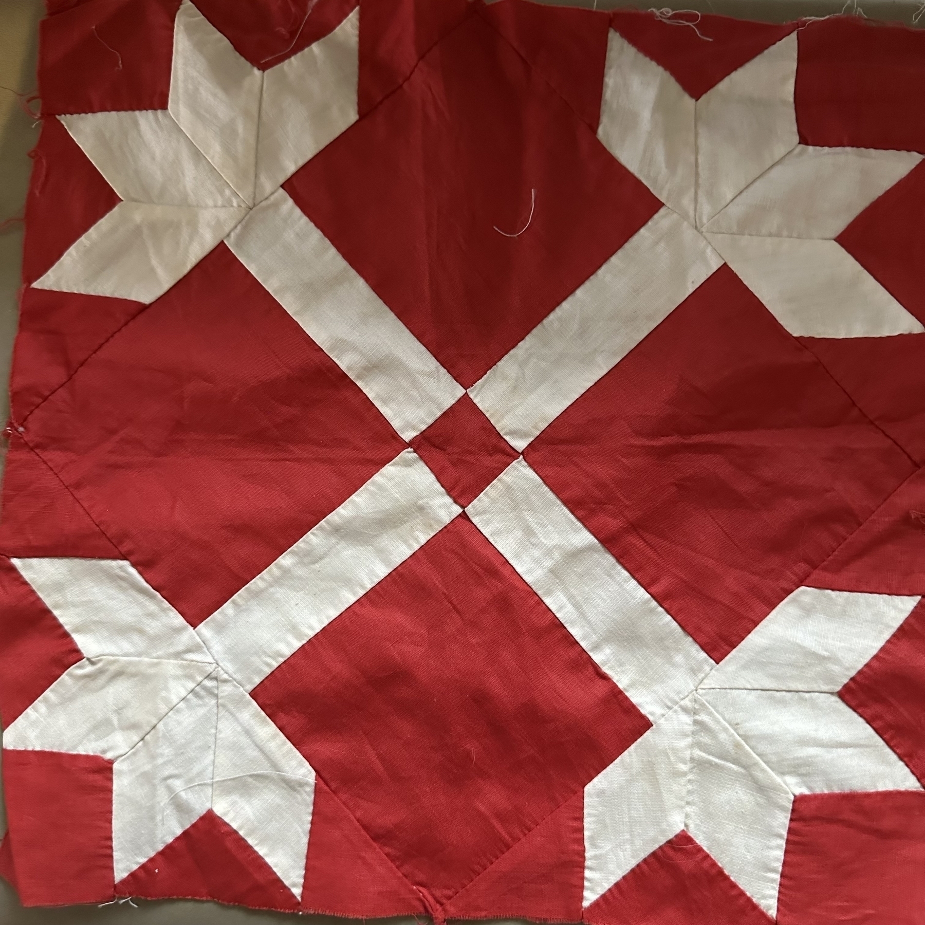 Mom’s hand sewn quilt piece in red.
