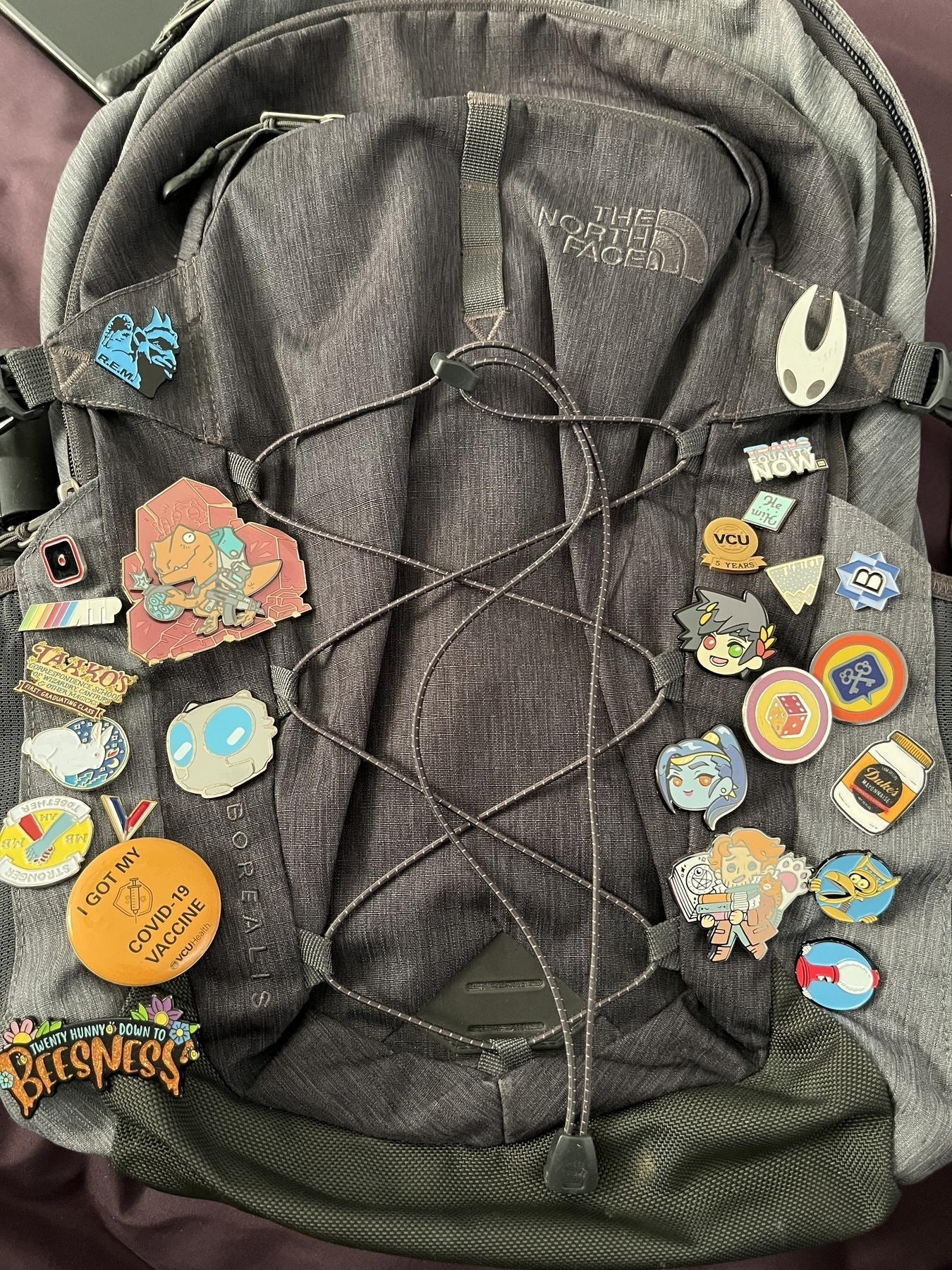 Sam’s backpack, full of pins, with the two new pins added.