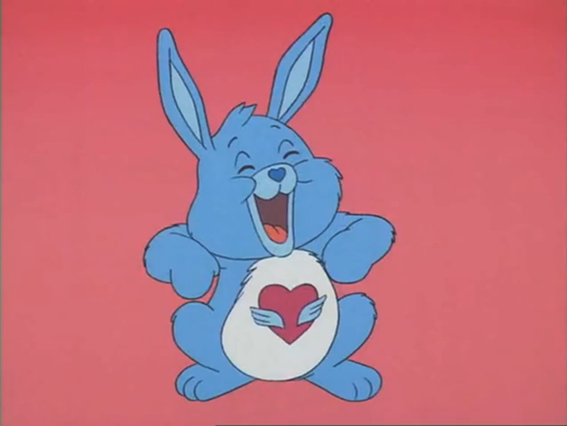 A picture of Swift Heart Rabbit, a Care Bear cousin. He/She is a blue rabbit with a white belly with a heart in the middle of it.