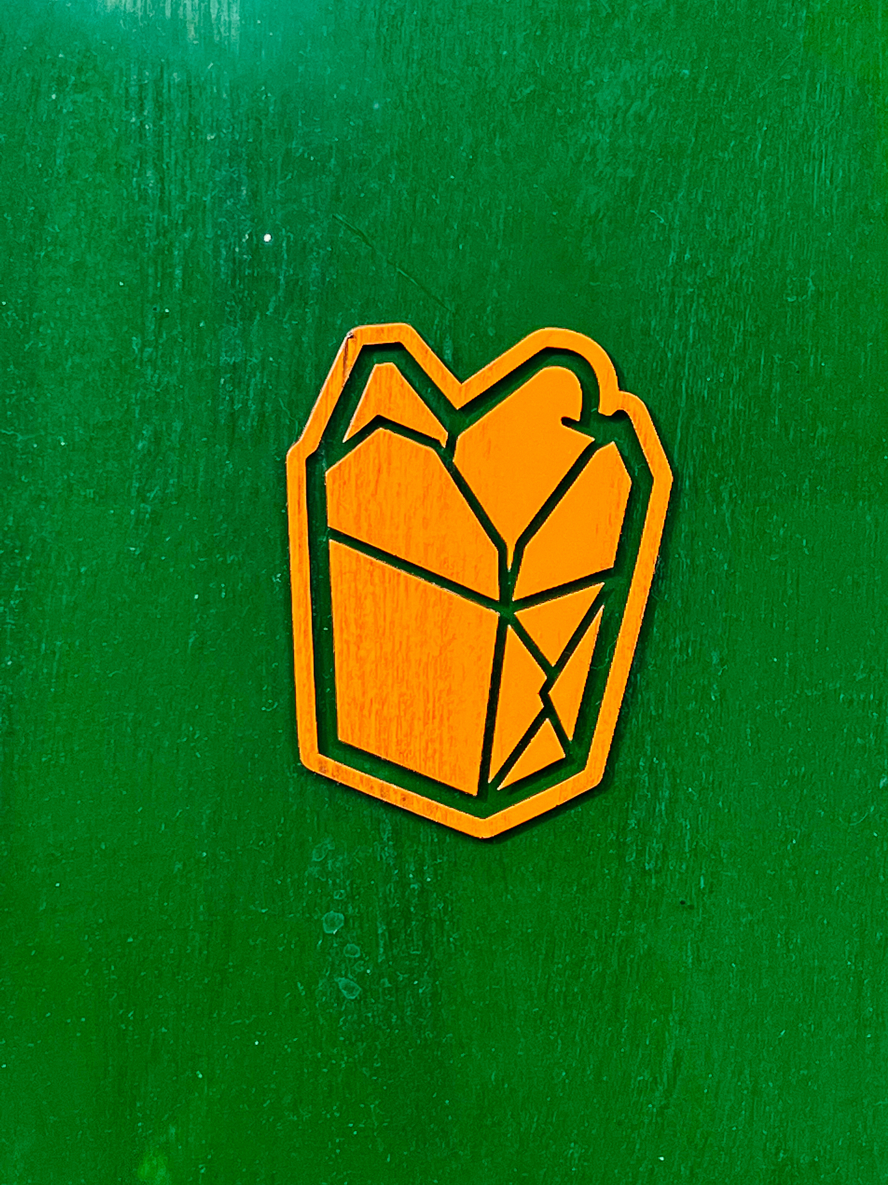 Sticker of an orange Chinese takeaway container in a green background