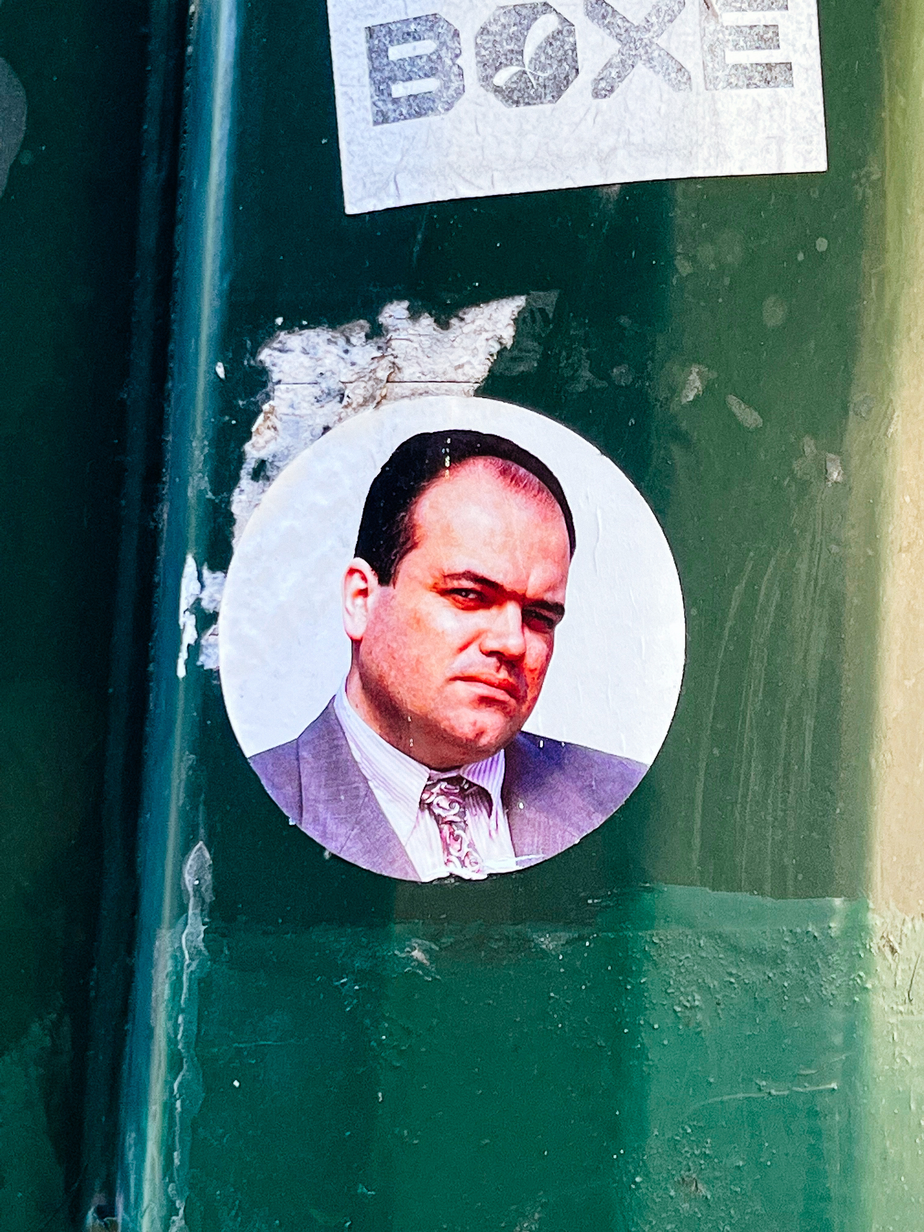 Sticker with the photo of a man looking at us. Not much more I can add, the man looks really unremarkable. 