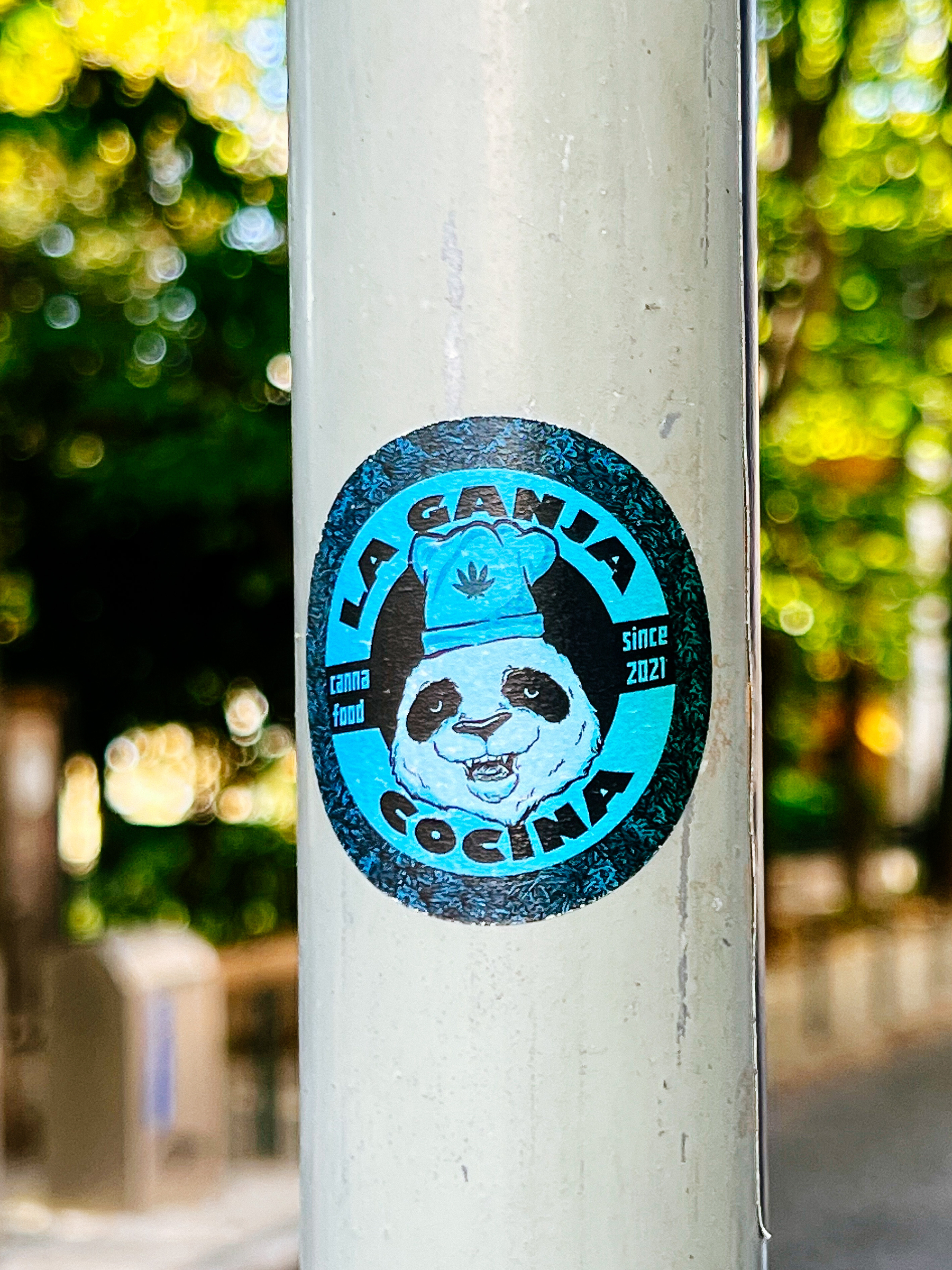 A sticker for “La Ganja Covina”, showing a very high panda with a hemp leaf on his chef’s hat. 