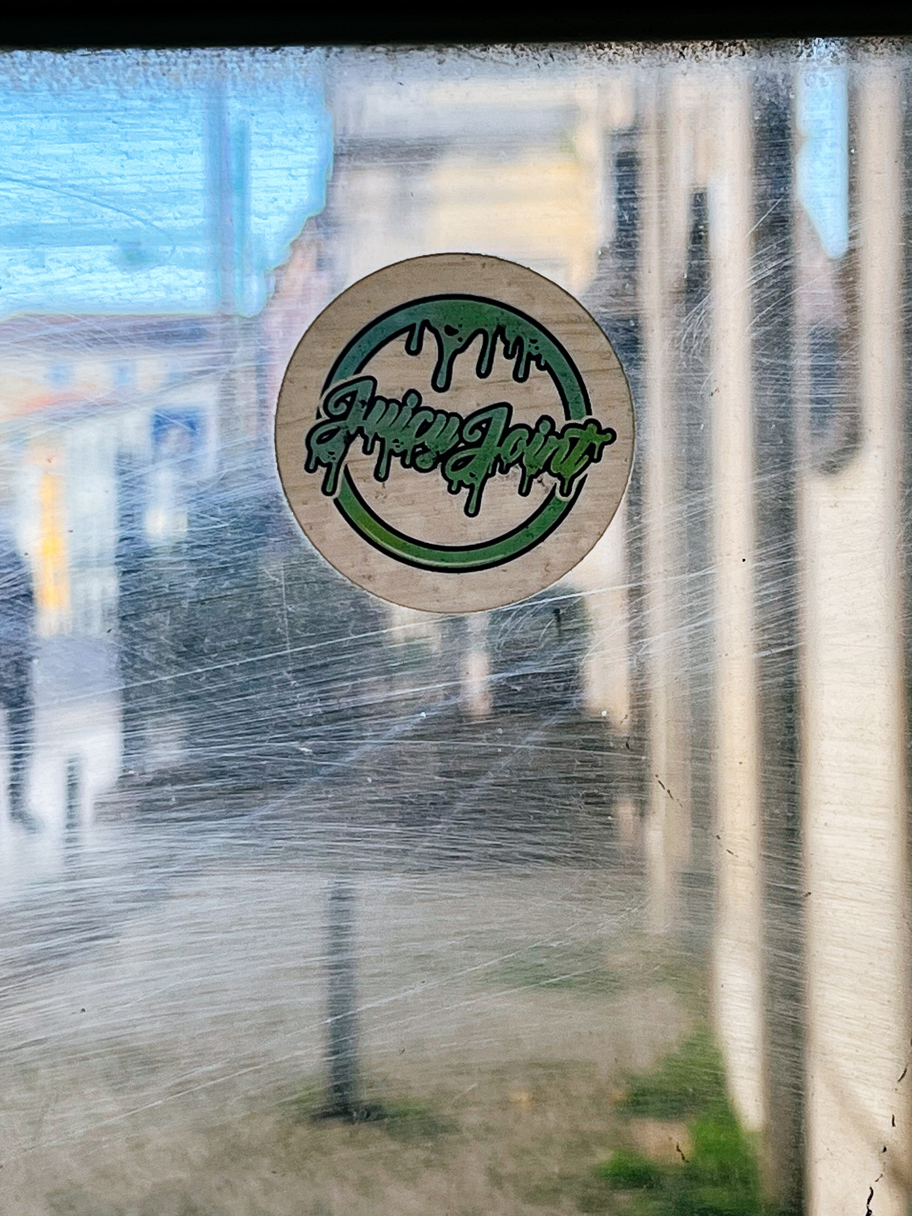 Sticker with the words “Juciy Joint”. 