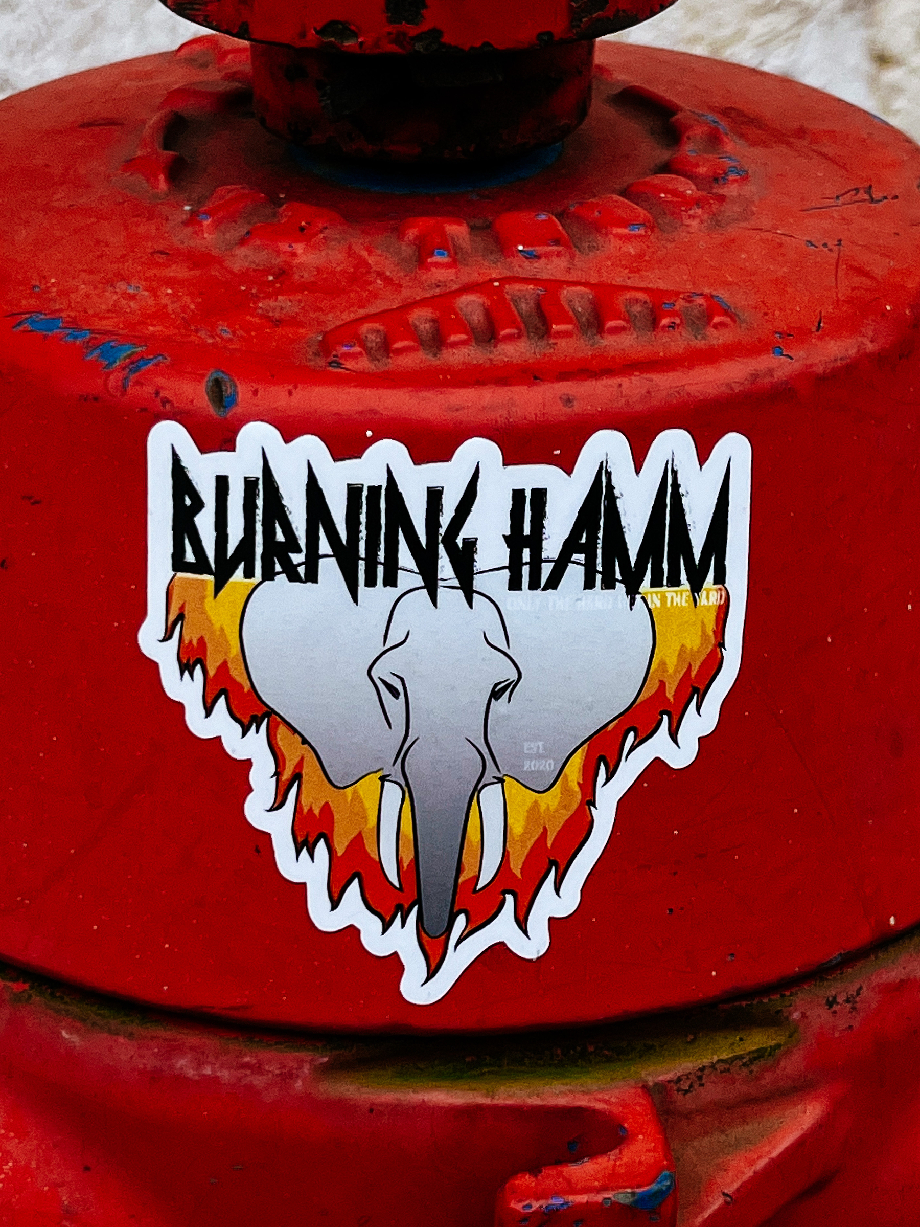 Sticker of an elephant’s head with flames around it, and the words “Burning Hamm”. 