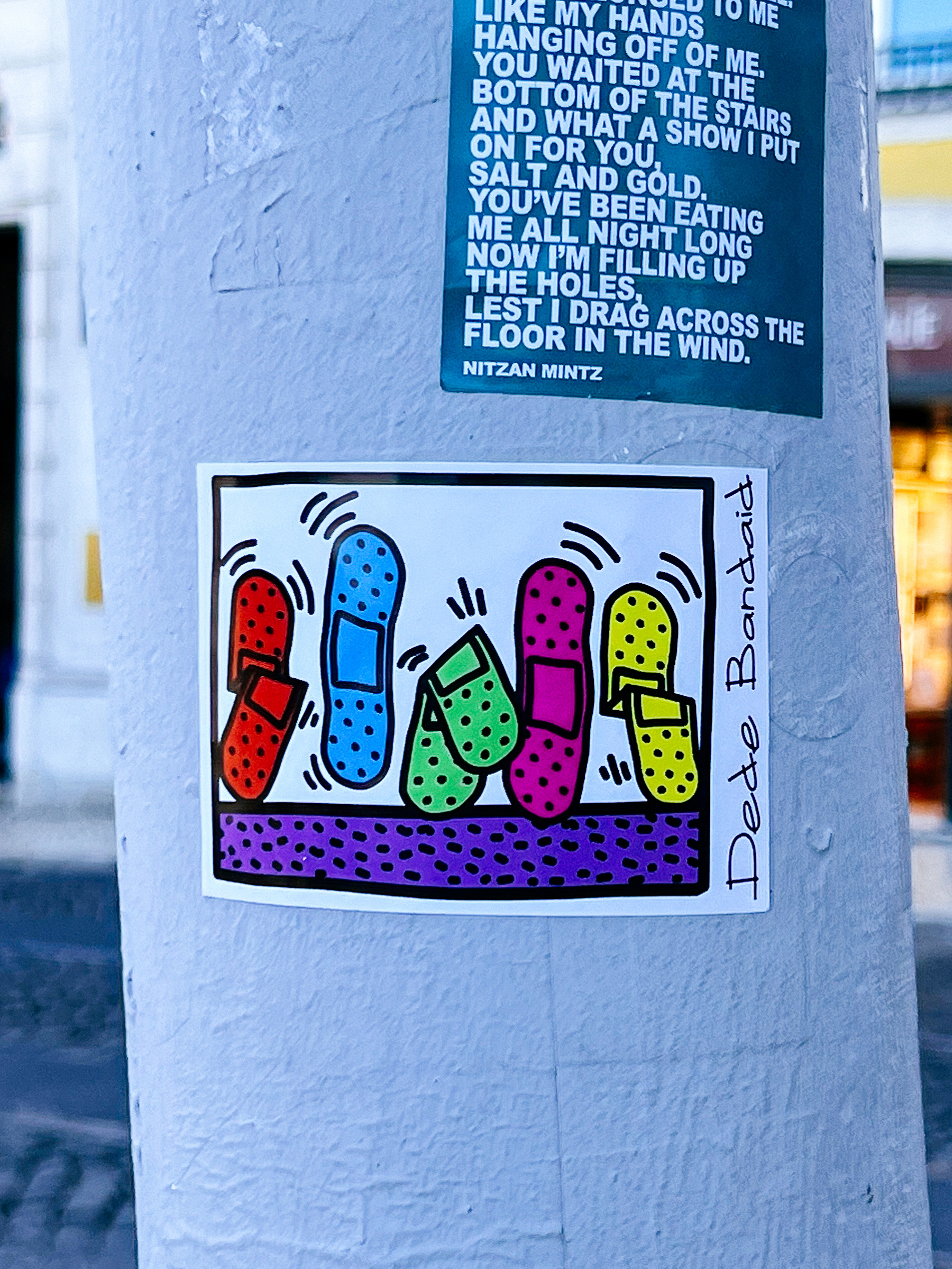 A sticker with colorful dancing bandaids. 