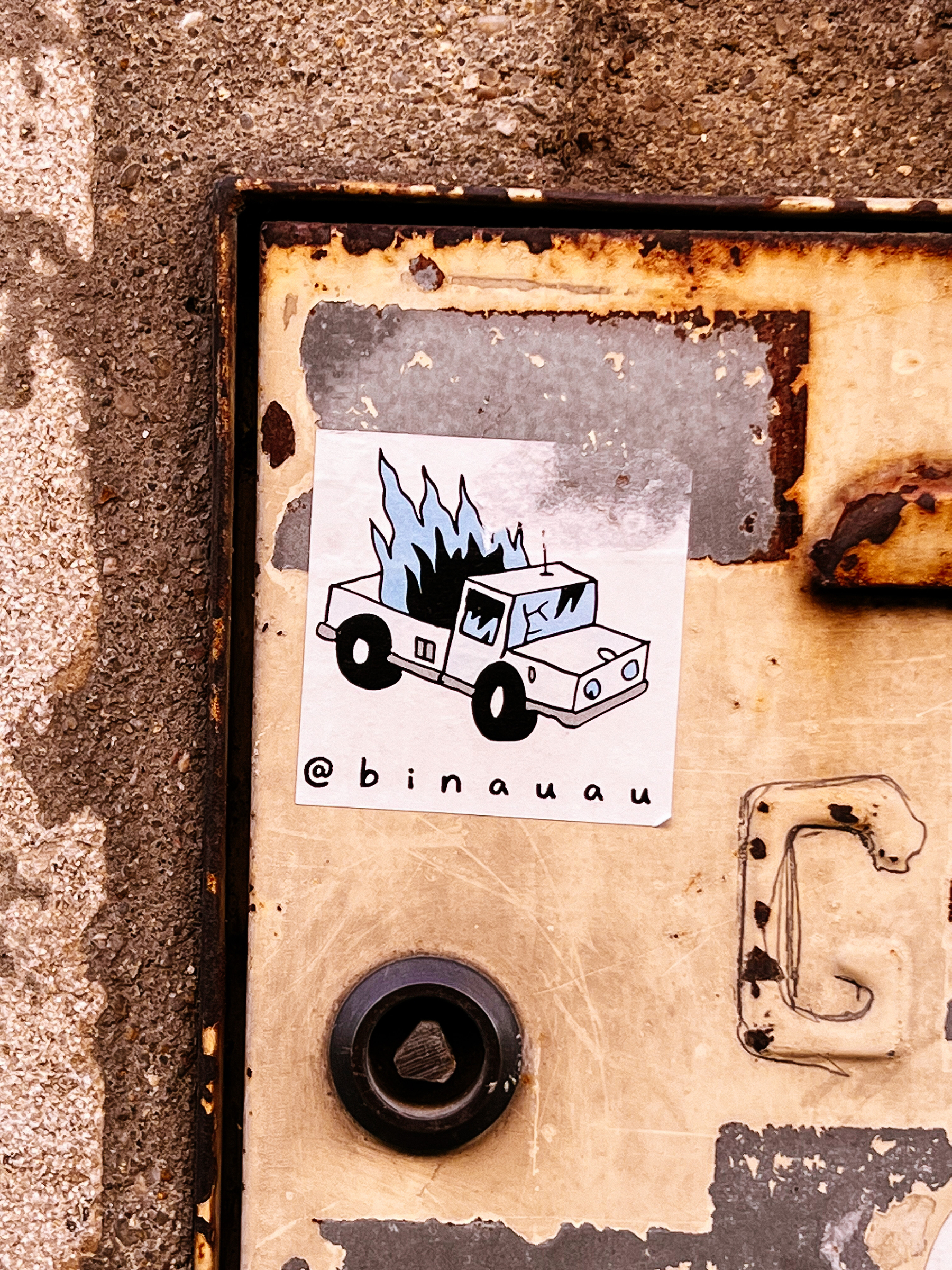 Sticker with a drawing of a boxy pickup truck with fire on the back. 