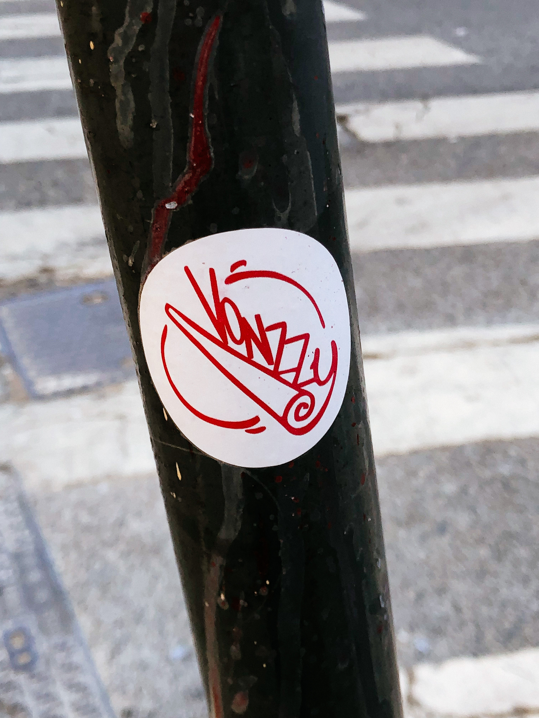Sticker of a rolled rolling paper, and the word “vonzyy” written next to it. 